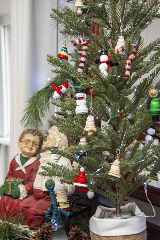 With a nod to the button-making business in Milton, buttons made of shells create miniature trees decorating a tabletop tree in the Mulberry Street home of Peggy and Ed Duckworth.